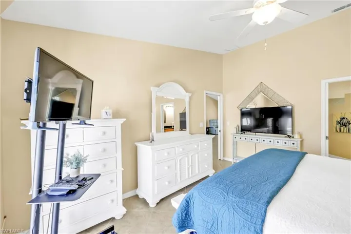Bedroom featuring visible vents, a ceiling fan, baseboards, and light tile patterned floors