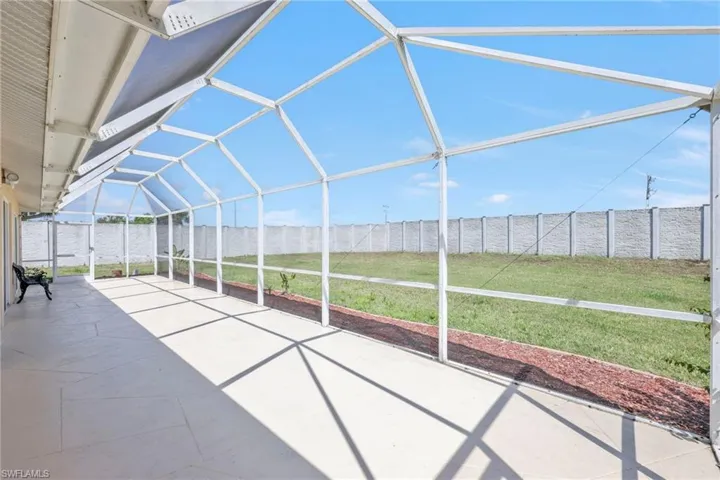 View of patio featuring a fenced backyard and a lanai