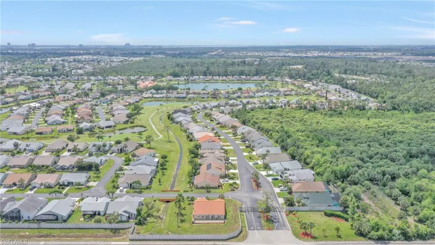 Aerial view with a forest view, a water view, and a residential view
