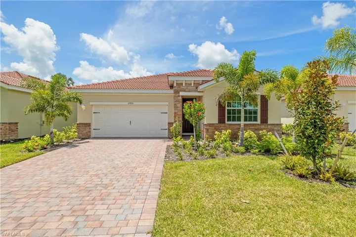 Mediterranean / spanish home featuring a garage and a front yard