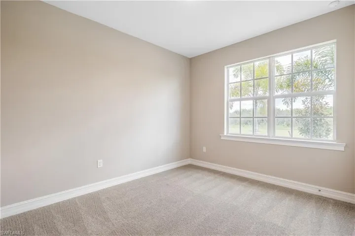 Carpeted empty room with a wealth of natural light