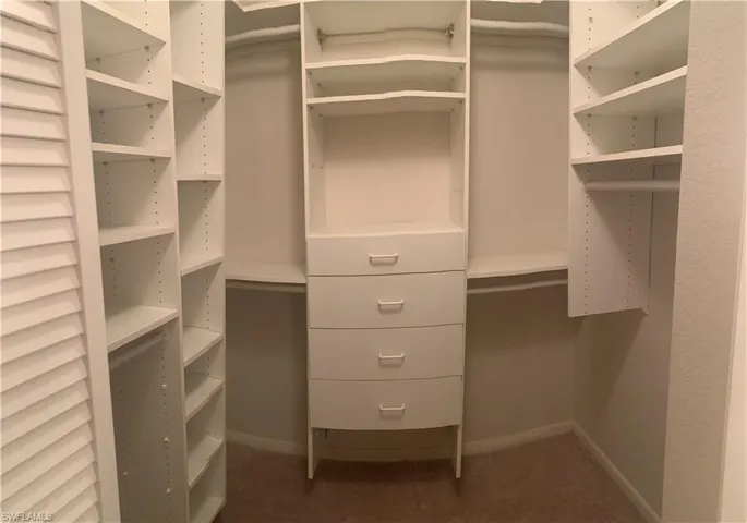 Master bedroom upstairs featuring carpet, a textured ceiling, ceiling fan, and lofted ceiling
