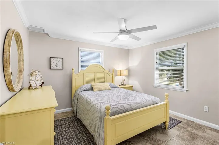 Bedroom with crown molding and ceiling fan