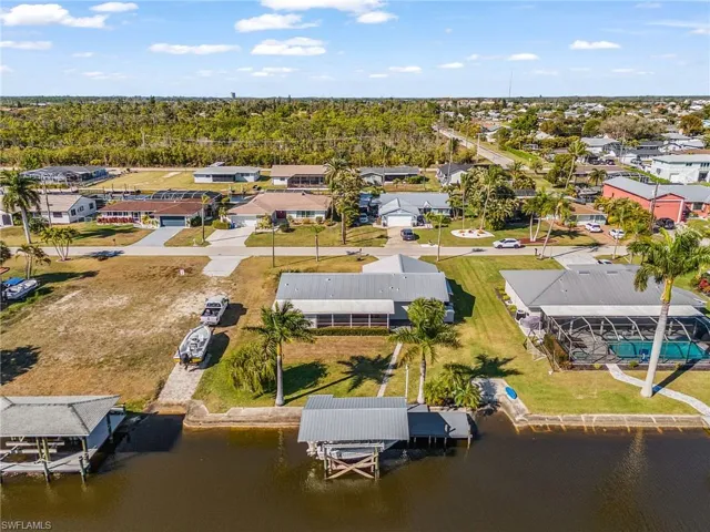 Aerial perspective of suburban area featuring a large body of water