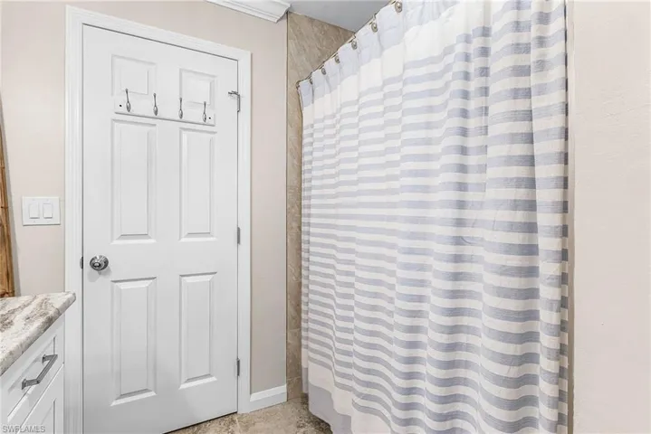 Bathroom featuring curtained shower and vanity