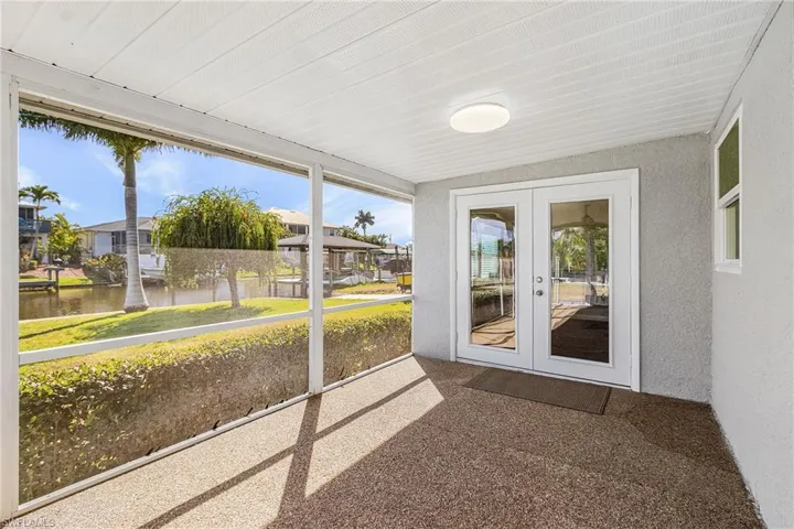 Unfurnished sunroom with french doors and a residential view