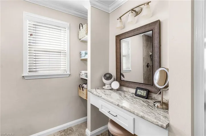 Full bathroom featuring ornamental molding and vanity