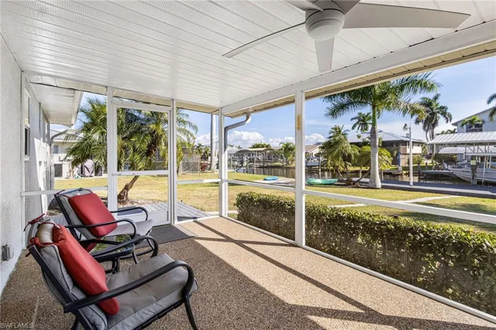 Sunroom featuring a water view and ceiling fan