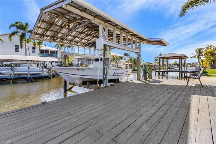 Dock with boat lift and a water view