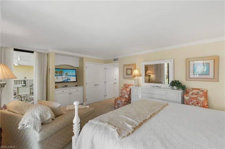 Bedroom with ornamental molding, a closet, and carpet floors