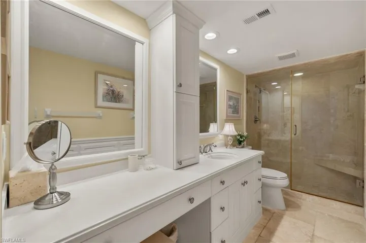 Full bathroom with vanity, a stall shower, and recessed lighting