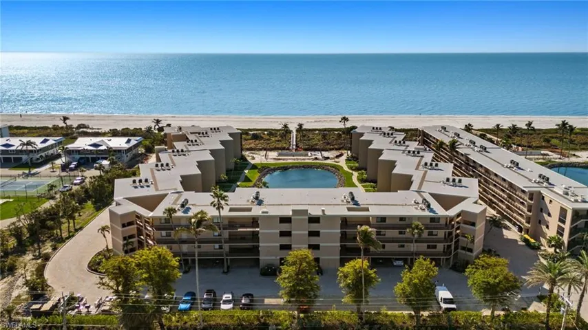 Bird's eye view of expansive coastline and apartment complex