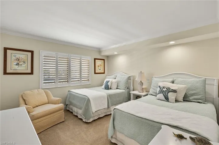 Bedroom featuring carpet and ornamental molding