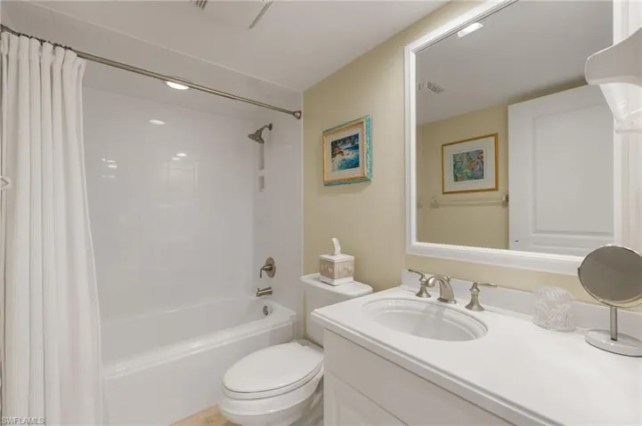 Full bathroom featuring shower / tub combo with curtain and vanity