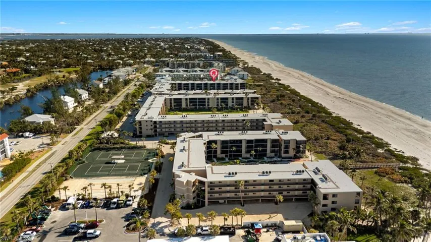 Drone / aerial view of expansive beach and apartment complex