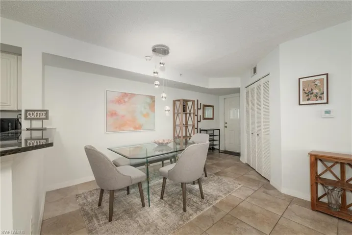 Dining space featuring a textured ceiling and baseboards