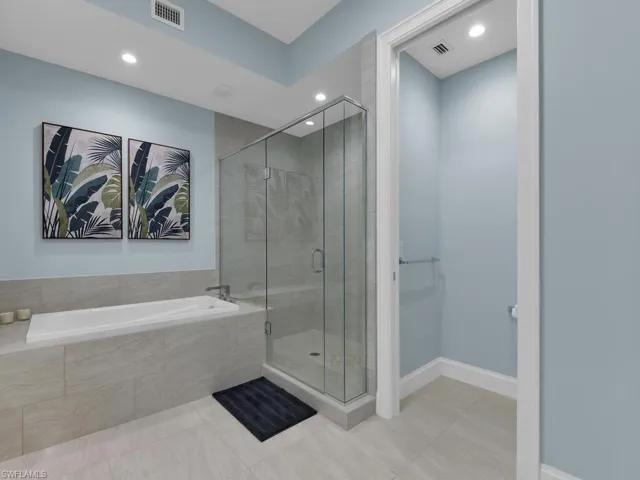 Full bath with a shower stall, a bath, light tile patterned floors, and recessed lighting