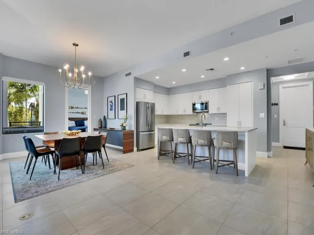 Dining space featuring a chandelier and light tile patterned floors