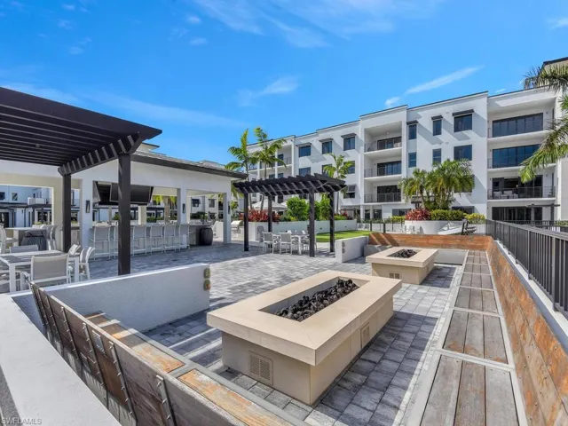 View of patio / terrace with a pergola, a fire pit, and outdoor dining area