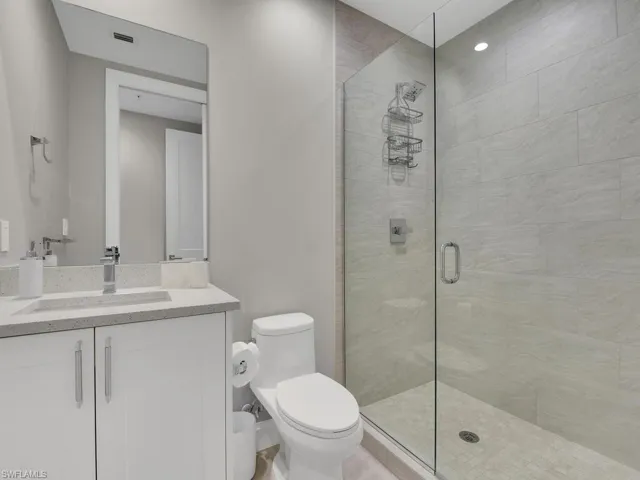 Bathroom with vanity and a shower stall