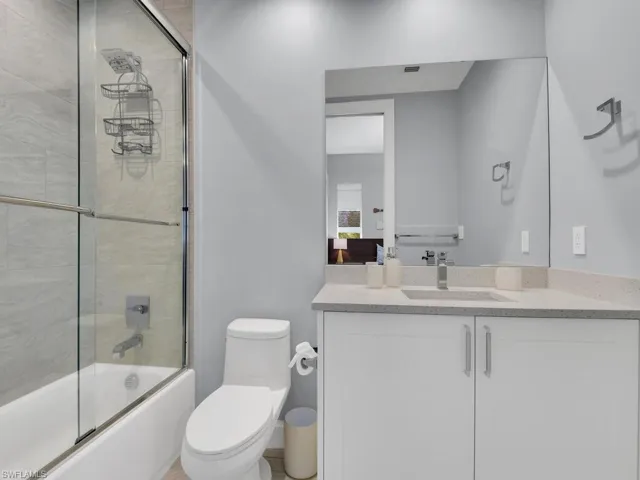Full bathroom with vanity and combined bath / shower with glass door