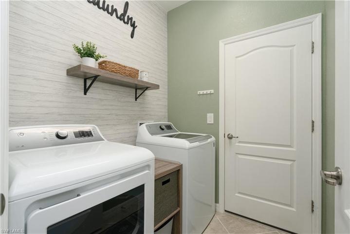 Laundry room off garage with washer and gas dryer.