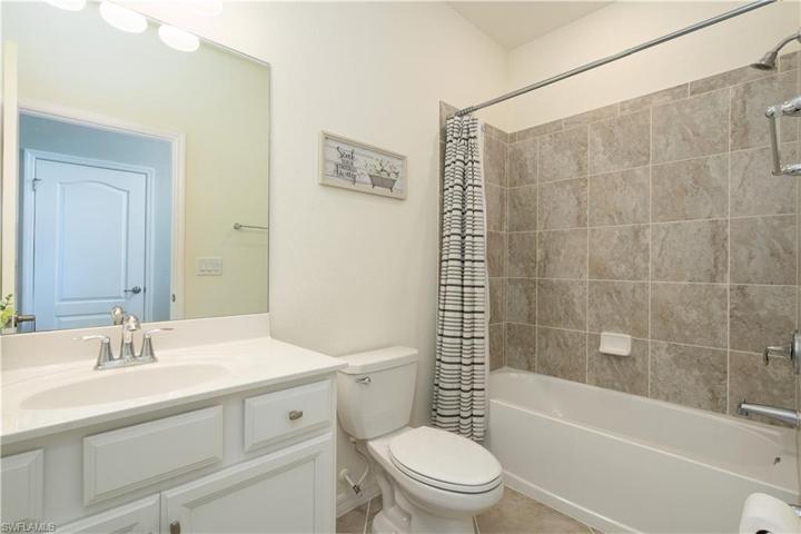 Main bathroom with tile shower and tub, granite tops on vanity