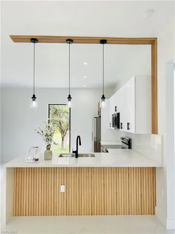 Kitchen island with wood-finish paneling and integrated sink