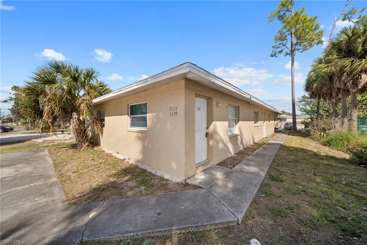 View of side of home featuring stucco siding