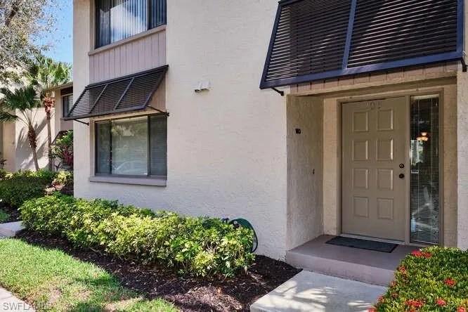 Doorway to property featuring stucco siding