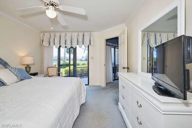 Bedroom featuring baseboards, a ceiling fan, light colored carpet, access to outside, and crown molding