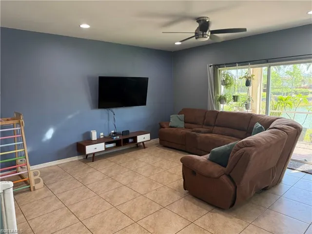 Spacious living area featuring tile flooring, recessed lighting, and a modern ceiling fan