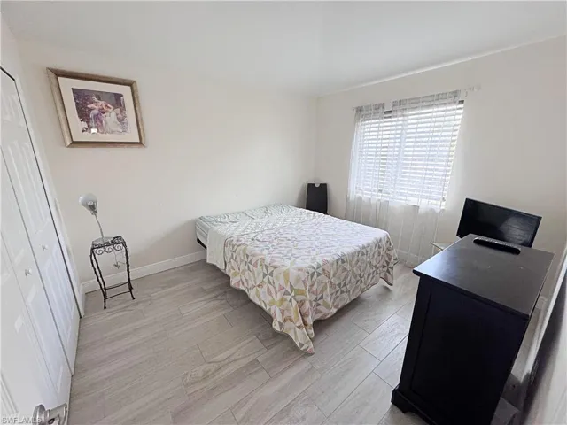 Second Bedroom featuring a closet and wood finish floors