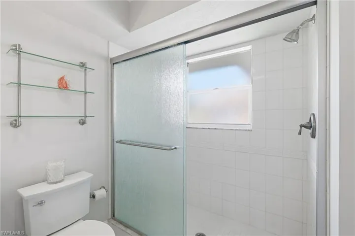 Tiled shower with frosted glass slider, chrome showerhead