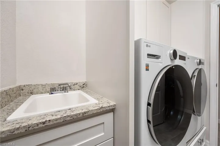 Washroom with washer / dryer and sink