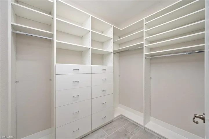 Spacious closet with light tile patterned floors
