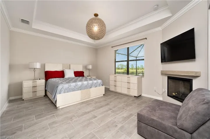 Bedroom with crown molding and a tray ceiling