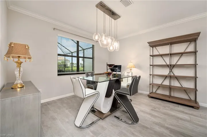 Dining space featuring light hardwood / wood-style floors and crown molding