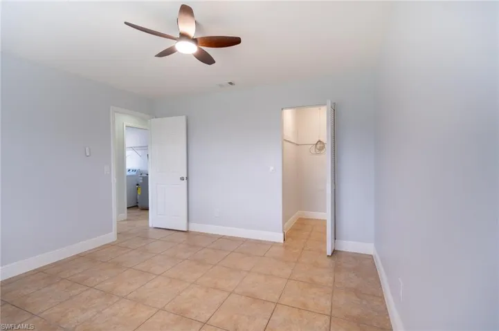 Spacious room with neutral wall tones and tile flooring