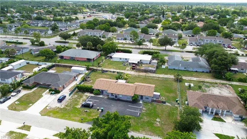Aerial perspective showcasing multiple residential structures and surrounding green spaces
