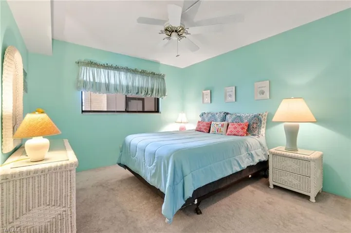 Carpeted bedroom with ceiling fan