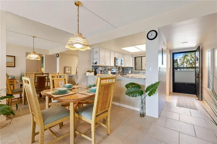 Dining area featuring light tile patterned floors and a textured ceiling