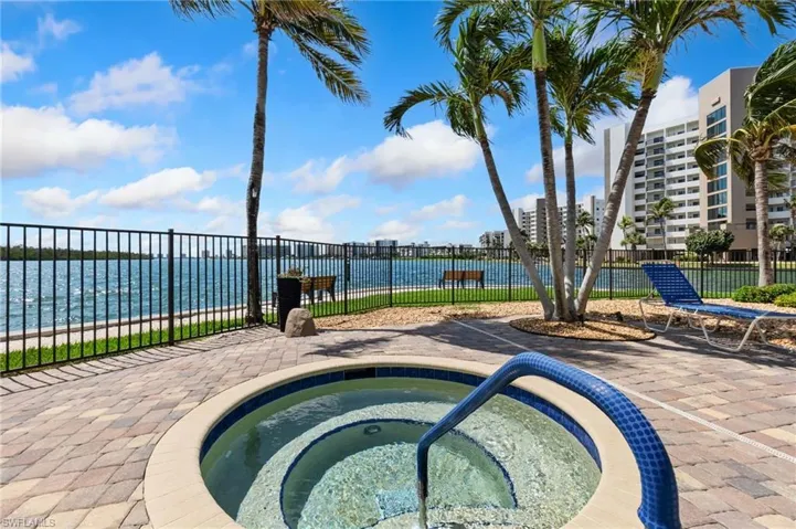 View of swimming pool with a community hot tub