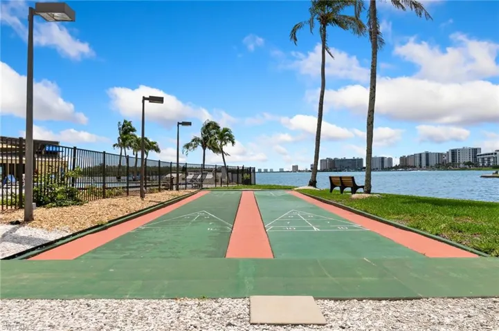 Surrounding community with shuffleboard and a water view