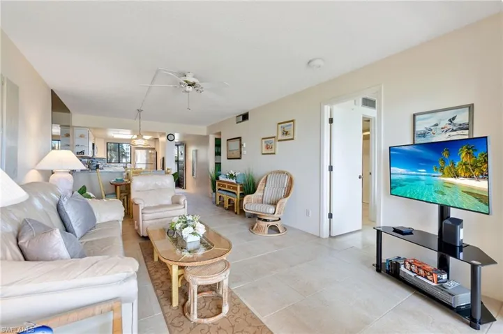 Living room featuring ceiling fan and light tile patterned flooring