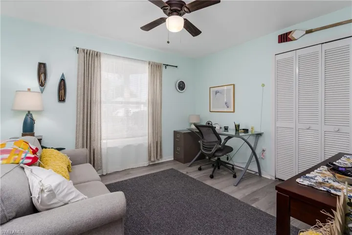 Office area with wood finished floors and ceiling fan