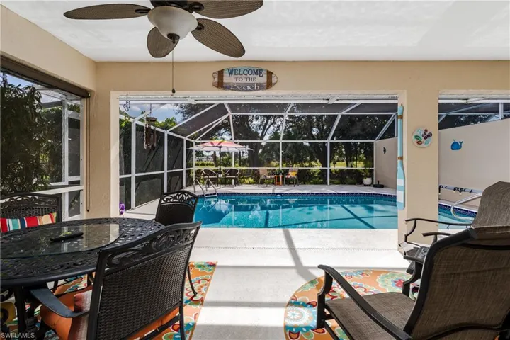 Outdoor pool featuring a patio, a lanai, ceiling fan, a sunroom, and outdoor dining space