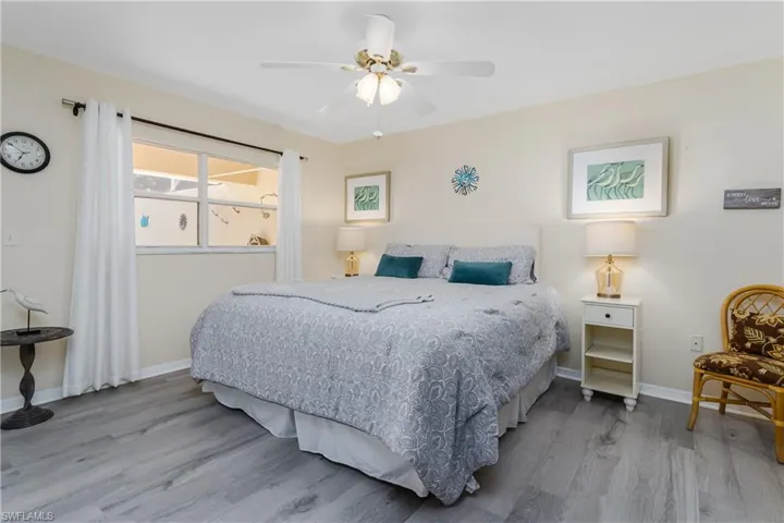 Bedroom featuring wood finished floors and a ceiling fan