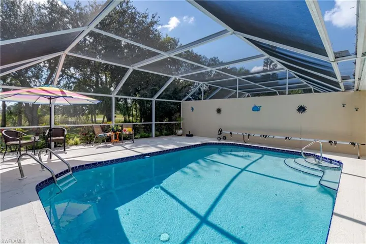 View of pool with a lanai, a patio area, and a sunroom