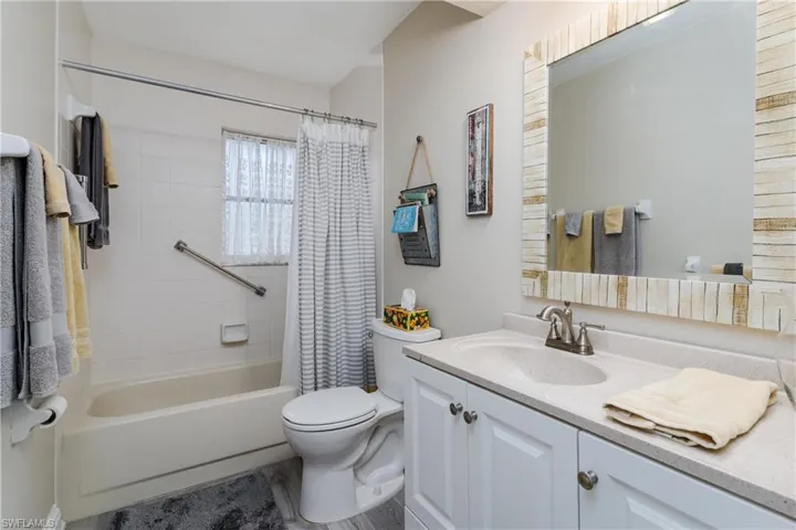 Full bath featuring vanity and shower / bath combo with shower curtain